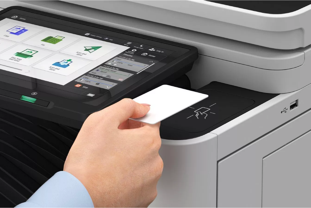 A user holds a UU campus card or personal card against the card reader of a Canon printer.