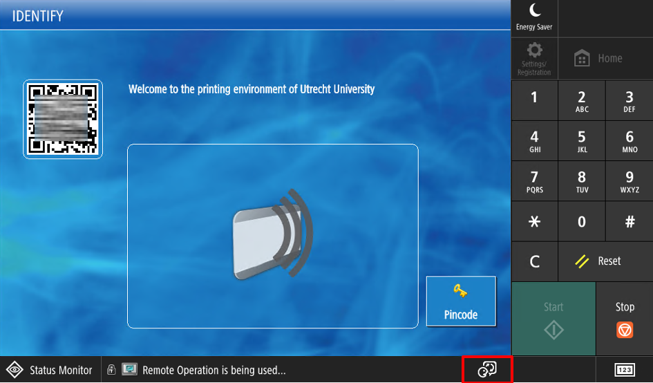 The Canon printer sign-in screen with the language icon highlighted at the bottom of the display.